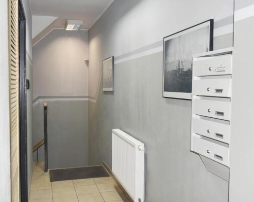 a hallway with a white radiator on a wall at Apartamenty Głowackiego in Sosnowiec