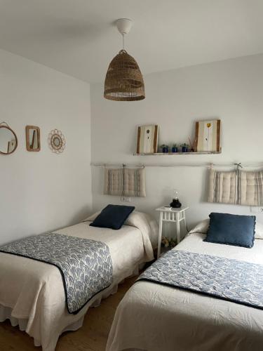 two beds in a room with white walls at VUT Santa Lucía in Zamora