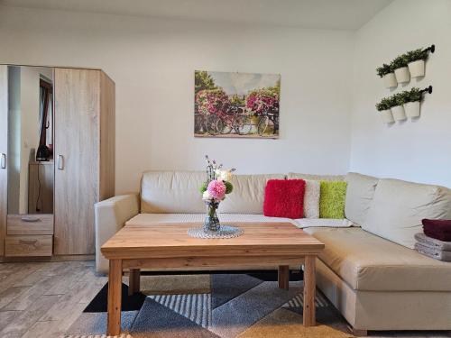 a living room with a couch and a coffee table at Chata Pod Strzechą in Lipusz