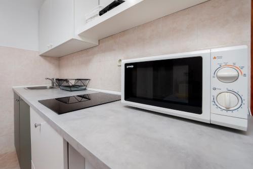 a microwave oven sitting on a counter in a kitchen at Apartments Luce in Rovinj