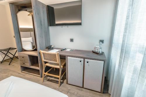 a room with a vanity with a chair and a mirror at HOTEL RURAL FINCA LA DESA in Miajadas