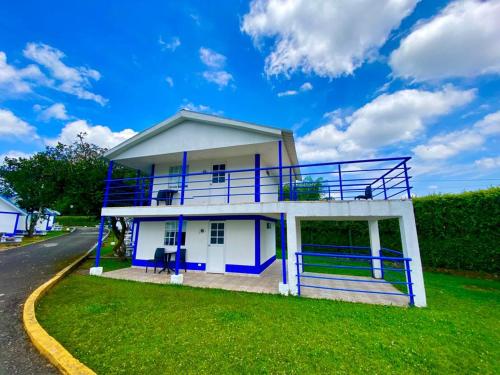 a white and blue building on the side of a road at Hotel Villa Mónaco in Pereira