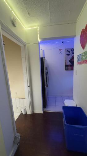 a bathroom with a blue ottoman in a room at Hotel Room 2 in Coquitlam