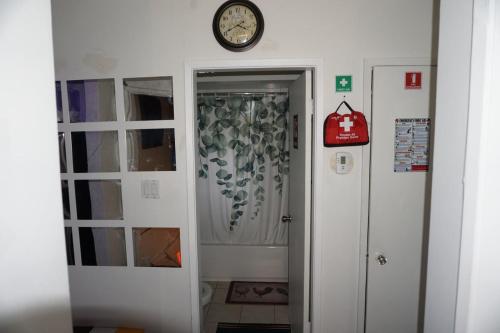 a clock on a wall next to a door at Hotel Room 2 in Coquitlam