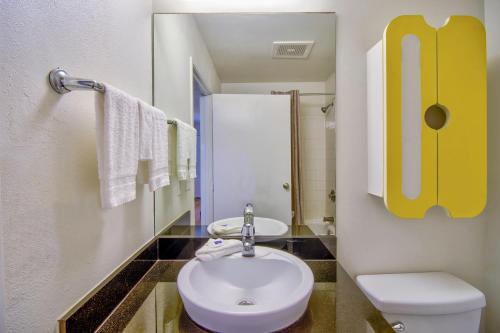 a bathroom with a white toilet and a sink at Studio 6-Phoenix, AZ - Deer Valley in Phoenix