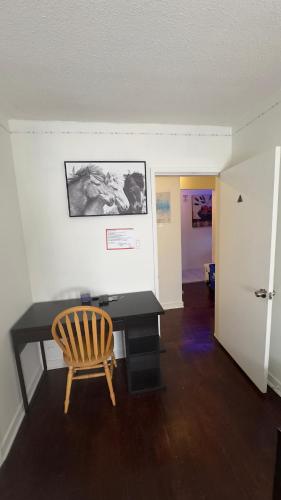 a office with a desk and a chair in a room at Hotel Room 2 in Coquitlam