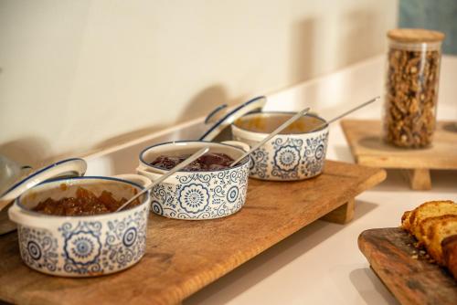 a group of three bowls of food on a cutting board at Christina Beach Hotel in Kissamos