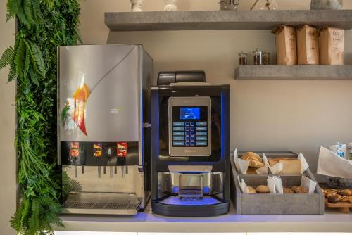 a coffee machine sitting on top of a shelf at Christina Beach Hotel in Kissamos