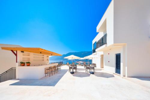 a patio with chairs and tables on a building at Lyxos Hotel in Kas