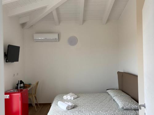 a bedroom with two beds and a red refrigerator at Domo Il Tramonto Giba in Giba