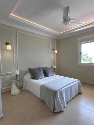 a white bedroom with a bed and a ceiling at Palacio de Sofia & Luxury in Asilah