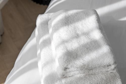 a white towel sitting on top of a white sink at Karoso rezidencija in Klaipėda