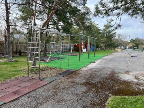 a park with a playground with a swing at Laulasmäe Puhkebaas in Laulasmaa