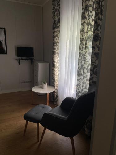 a living room with a chair and a table at Ringi studio in Pärnu