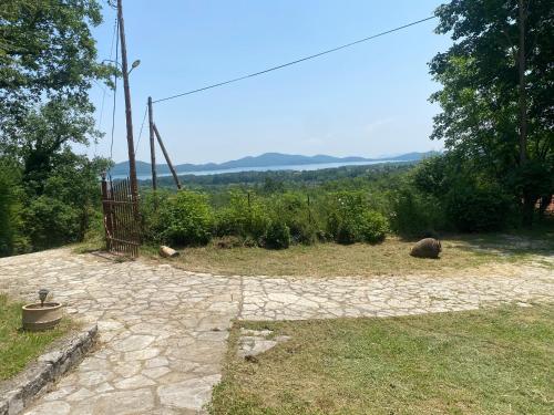 a stone patio with a view of the mountains at To σαλέ της λίμνης 2 in Kalyvia Fylaktis