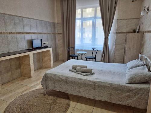 a bedroom with a bed and a table with chairs at Pechersk House in Kyiv