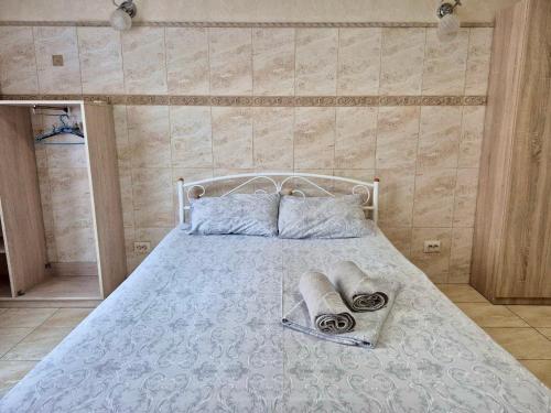 a bedroom with a bed with two towels on it at Pechersk House in Kyiv