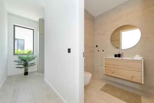 a bathroom with a sink and a mirror at Cloud 9 D7 in Tkon