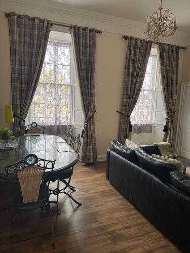 a living room with a table and a couch at 52, Charlotte Street Apartments in Glasgow