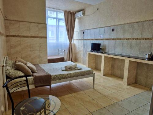 a bedroom with a bed and a table in a room at Pechersk House in Kyiv