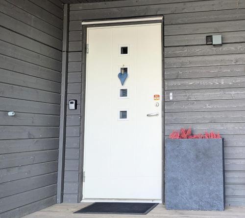 a white door on the side of a house at The House of Aurora I in Tromsø