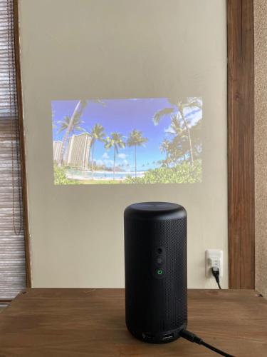 a black speaker sitting on top of a table at ゲストハウス真鶴の家-Guest House Manazuru House in Manazuru