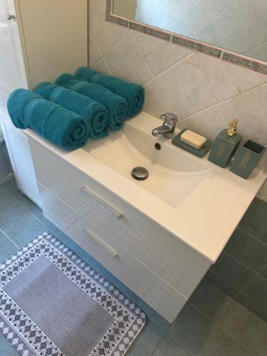 a bathroom with a white sink and a mirror at Casa Liliana in Ladispoli