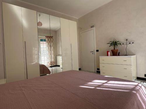 a bedroom with a bed and a dresser and a mirror at Casa Liliana in Ladispoli