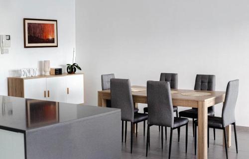 a dining room with a wooden table and chairs at Brilliance of the sea apt in St Julian's