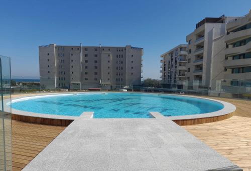 a large swimming pool in the middle of some buildings at Studio 616 SunnyVibes in Mamaia Nord