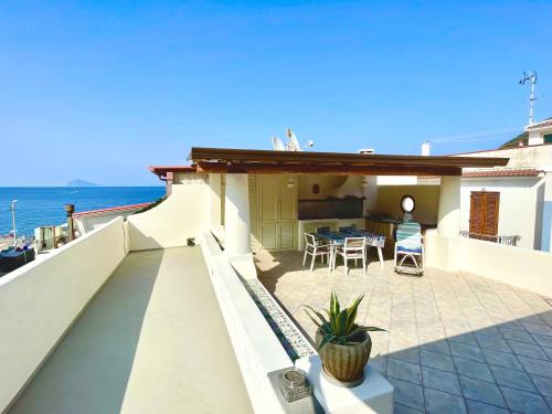 a balcony of a house with a table and chairs at CasaEolia Blues in Canneto