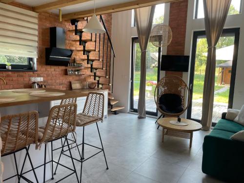 a kitchen and living room with a counter and chairs at Makówka in Mysłakowice