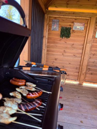 a grill with hot dogs and sausages on it at Makówka in Mysłakowice
