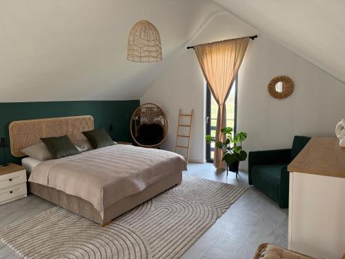 a bedroom with a bed and a green wall at Makówka in Mysłakowice