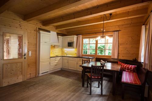 a kitchen with a table and chairs in a cabin at Hubers Chalet in Mayrhofen