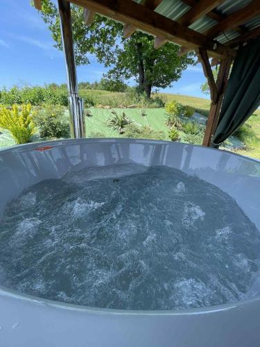 a hot tub filled with water under a roof at Zielona Dolina Hoczew in Hoczew