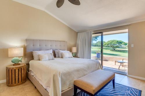 a bedroom with a large bed and a balcony at Kapalua Golf Villas 15P3-4 in Kahana