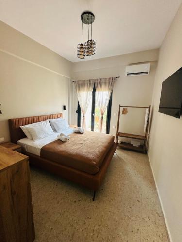 a bedroom with a large bed and a window at Villa Agora in Nikiti