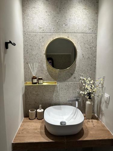 a bathroom with a white sink and a mirror at Villa Agora in Nikiti