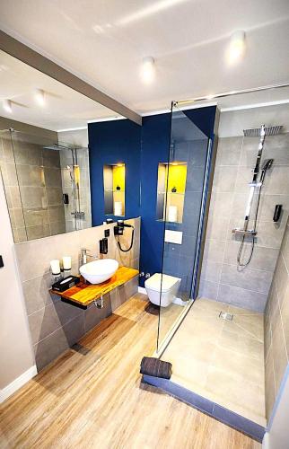 a bathroom with a sink and a shower and a toilet at Neueröffnung Liro Hotel Mönchengladbach in Mönchengladbach