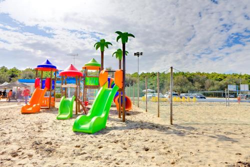 a playground on the beach with a bunch of slides at Hotel Columbia in Marina Romea