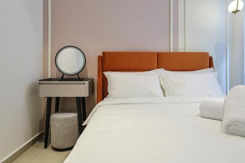 a bedroom with a bed with a mirror on a table at Paxtonz Exsim By NexxField in Petaling Jaya