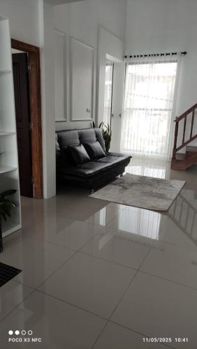 a living room with a couch and a table at Titik Senja Vila Dieng in Dieng