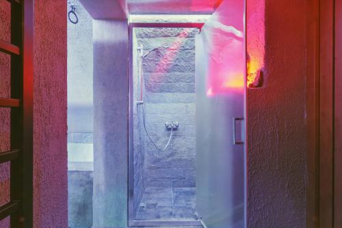 a bathroom with a shower with a glass door at Letohrádok in Vlachovo