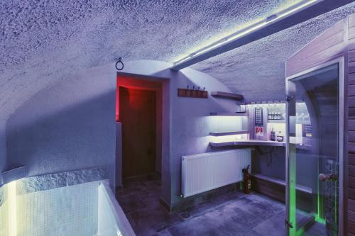 a hallway with a red door and purple walls at Letohrádok in Vlachovo