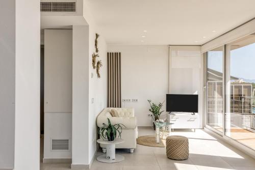 TV a/nebo společenská místnost v ubytování Penthouse l'Escala