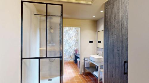 a bathroom with a glass shower and a sink at Arcs De Monells - Adults Only in Monells