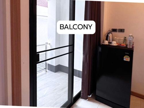a black door with a balcony in a room at Maesai Bliss Residence in Ban Pa Yang