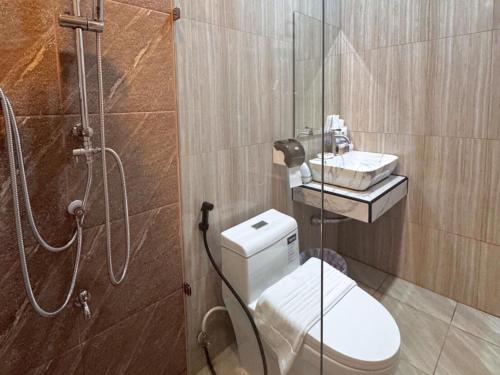 a bathroom with a shower and a toilet and a sink at Maesai Bliss Residence in Ban Pa Yang