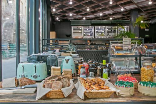 a table with bread and other food items on it at Niu Barcelona Hotel in Barcelona